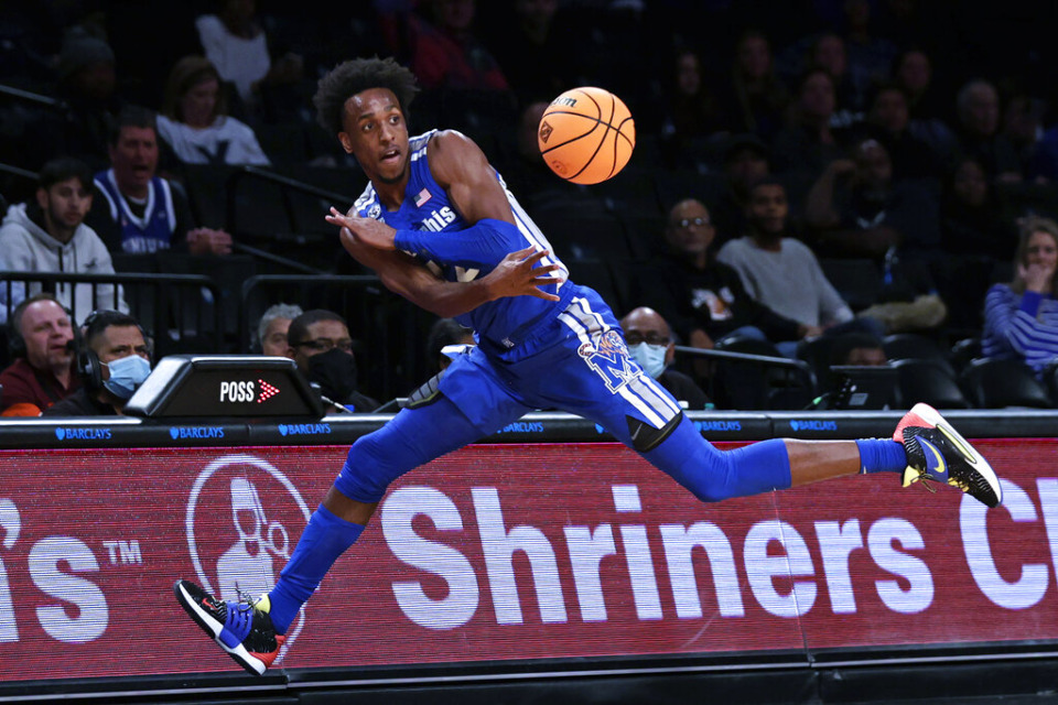 <strong>Memphis's DeAndre Williams saves the ball from going out of bounds during the first half of an NCAA college basketball game against Virginia Tech in the NIT Season Tip-Off tournament Wednesday, Nov. 24, 2021, in New York.</strong> (AP Photo/Adam Hunger)