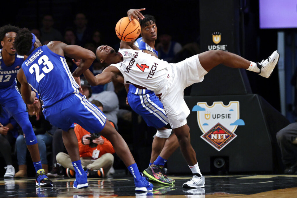 <strong>Virginia Tech's Nahiem Alleyne (4) battles for the ball with Memphis' Malcolm Dandridge (23) during the first half of an NCAA college basketball game in the NIT Season Tip-Off tournament Wednesday, Nov. 24, 2021, in New York.</strong> (AP Photo/Adam Hunger)