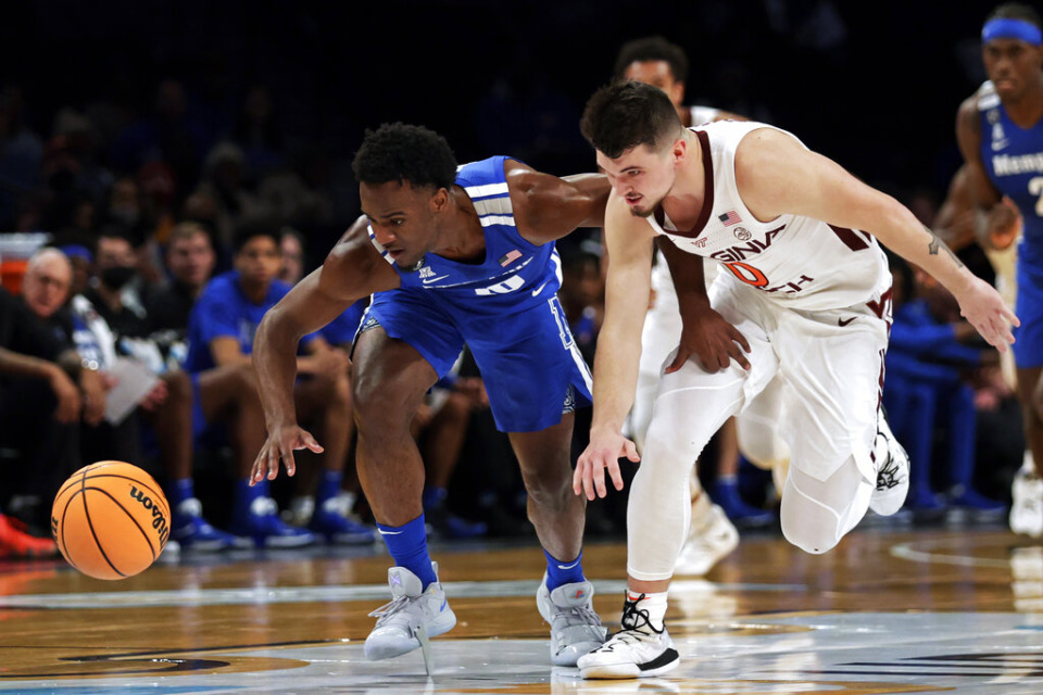 <strong>Memphis' Alex Lomax and Virginia Tech's Hunter Cattoor (0) scramble for the ball during the first half of an NCAA college basketball game in the NIT Season Tip-Off tournament Wednesday, Nov. 24, 2021, in New York</strong>. (AP Photo/Adam Hunger)