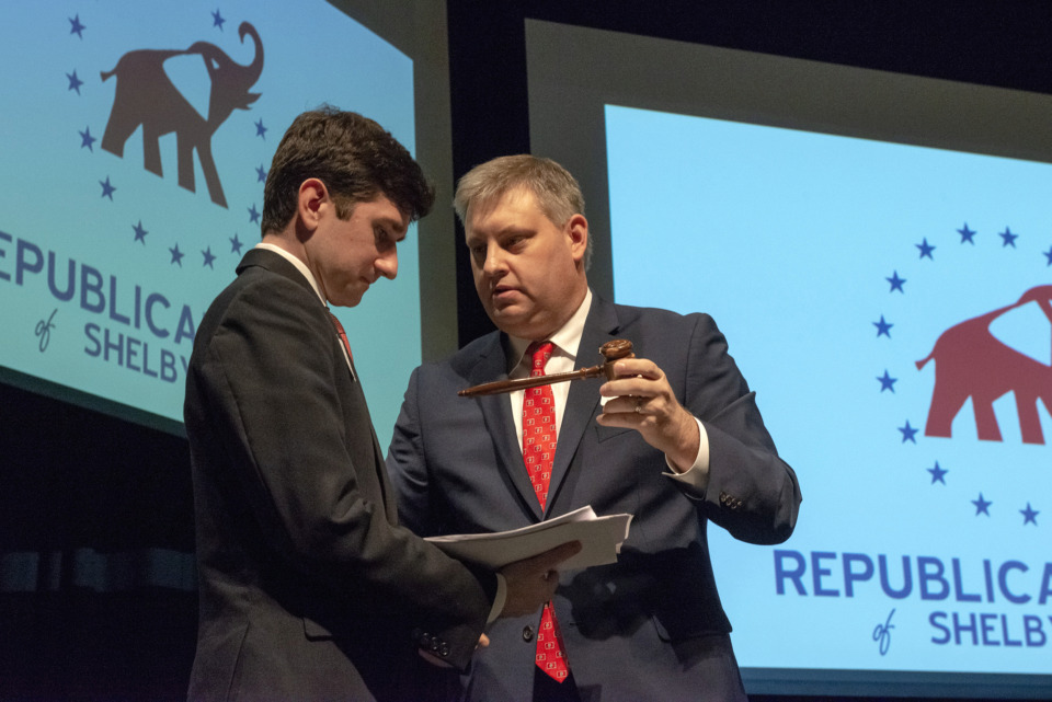 <strong>Lee Mills (right), outgoing chairman of the Republican Party of Shelby County, hands the gavel to new chairman Chris Tutor during the party's 2019 convention at Arlington High School on Sunday, Feb. 24, in Arlington.</strong> (Brandon Dill/Special to The Daily Memphian)