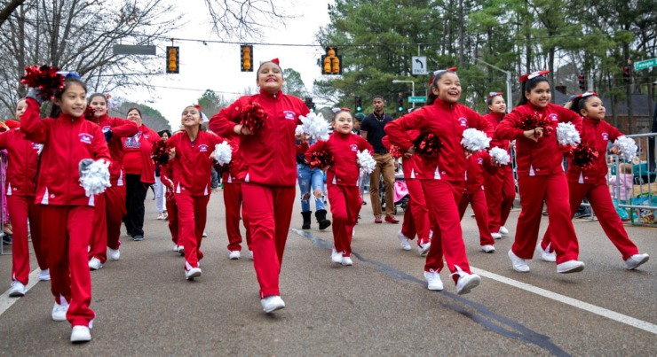 The Wells Station cheer squad marches along West Farmington Boulevard during the Germantown Christmas parade on Dec. 14, 2019. (Mike Kerr/Special to The Daily Memphian)