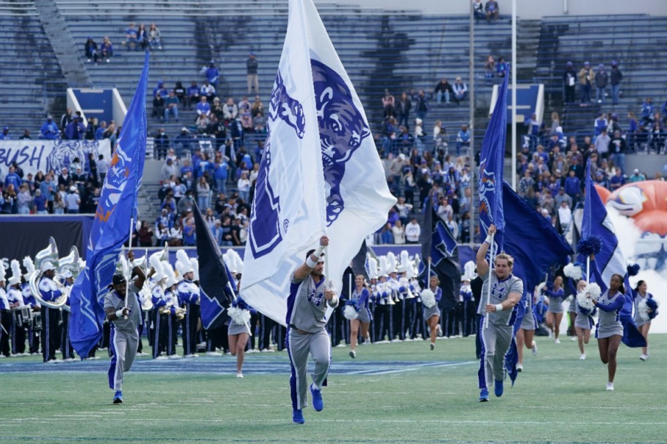 <strong>Memphis cheerleaders run onto the field before an NCAA college football game between Memphis and SMU Saturday, Nov. 6, 2021, in Memphis, Tenn.</strong> (AP Photo/Mark Humphrey)