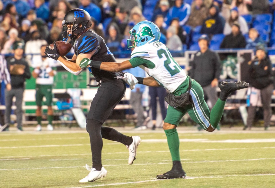 <strong>Memphis wide receiver Koby Drake snags a short pass by Memphis quarterback Seth Henigan in the first half of the final regular season game Saturday, Nov. 27, 2021. Tulane's defensive back Jadon Canady defends. Memphis held on to win 33-28.</strong> (Greg Campbell/Special to The Daily Memphian)