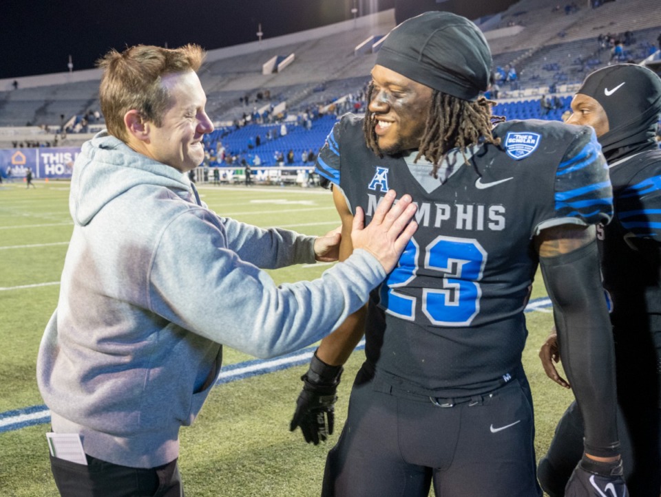 <strong>Memphis head coach Ryan Silverfield congratulates linebacker JJ Russell after Memphis' 33-28 win over Tulane in the final regular season game Saturday, Nov. 27, 2021.</strong> (Greg Campbell/Special to The Daily Memphian)