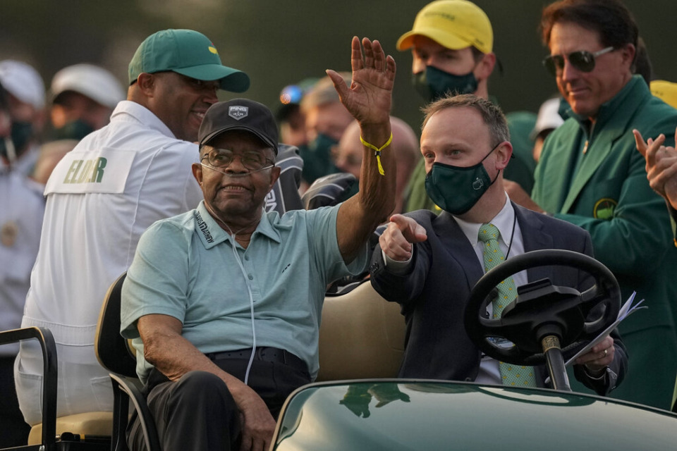<strong>Lee Elder waves as he arrives for the ceremonial tee shots before the first round of the Masters golf tournament on Thursday, April 8, 2021, in Augusta, Ga. At far right is Phil Mickelson.</strong> (AP Photo/Charlie Riedel, File)