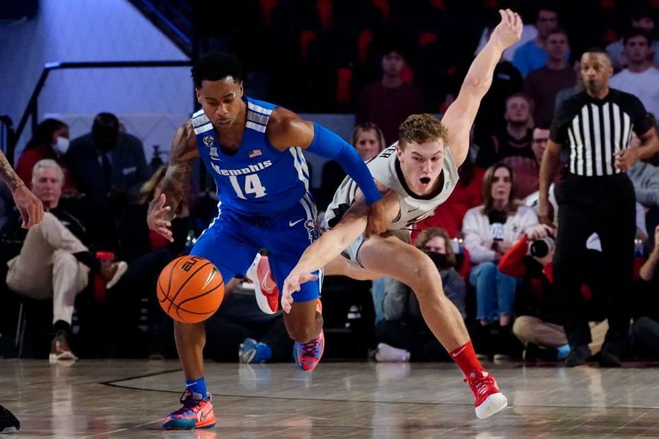 <strong>Memphis guard Tyler Harris (left) and Georgia forward Jaxon Etter chase a loose ball during the first half of their game Wednesday, Dec. 1, in Athens.</strong> <strong>Georgia snatched a&nbsp;victory from the Tigers in the final two minutes, 82-79.</strong> (John Bazemore/Associated Press)