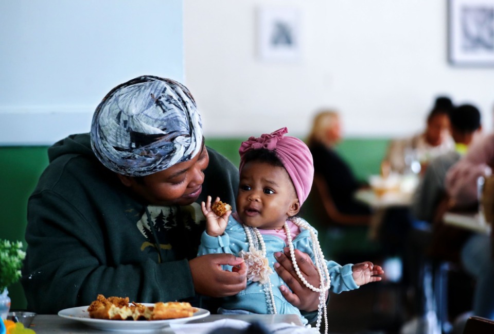<strong>Simone Lampkin feeds her daughter, Samira Chapman, some of her chicken and waffles at Biscuits &amp; Jams in Bartlett.</strong> (Patrick Lantrip/Daily Memphian)