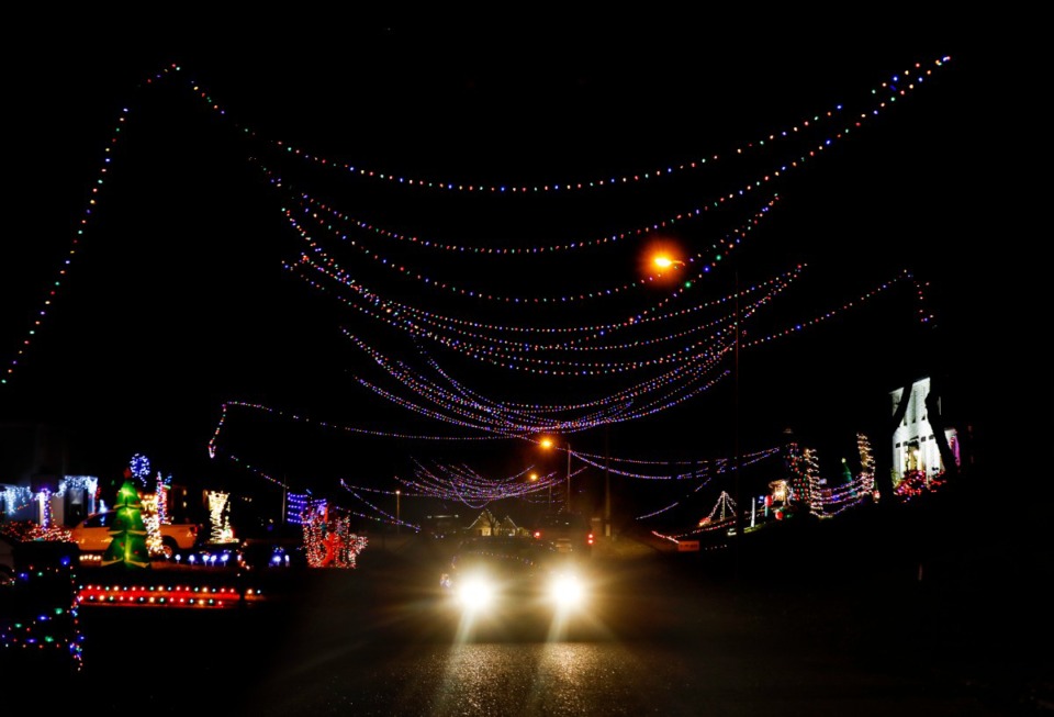 <strong>Cars drive under Christmas lights strung from house to house on Six Crowns Street in Collierville on Tuesday, Nov. 30. Neighbors on the street came together to create a tunnel of lights for the community to enjoy.</strong> (Mark Weber/Daily Memphian)