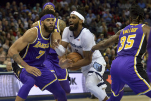 <span><strong>Memphis Grizzlies guard Mike Conley, center, drives between Los Angeles Lakers center JaVale McGee (7) and guard Reggie Bullock (35) in the second half of an NBA basketball game Monday, Feb. 25, 2019, in Memphis, Tenn.</strong> (AP Photo/Brandon Dill)</span>