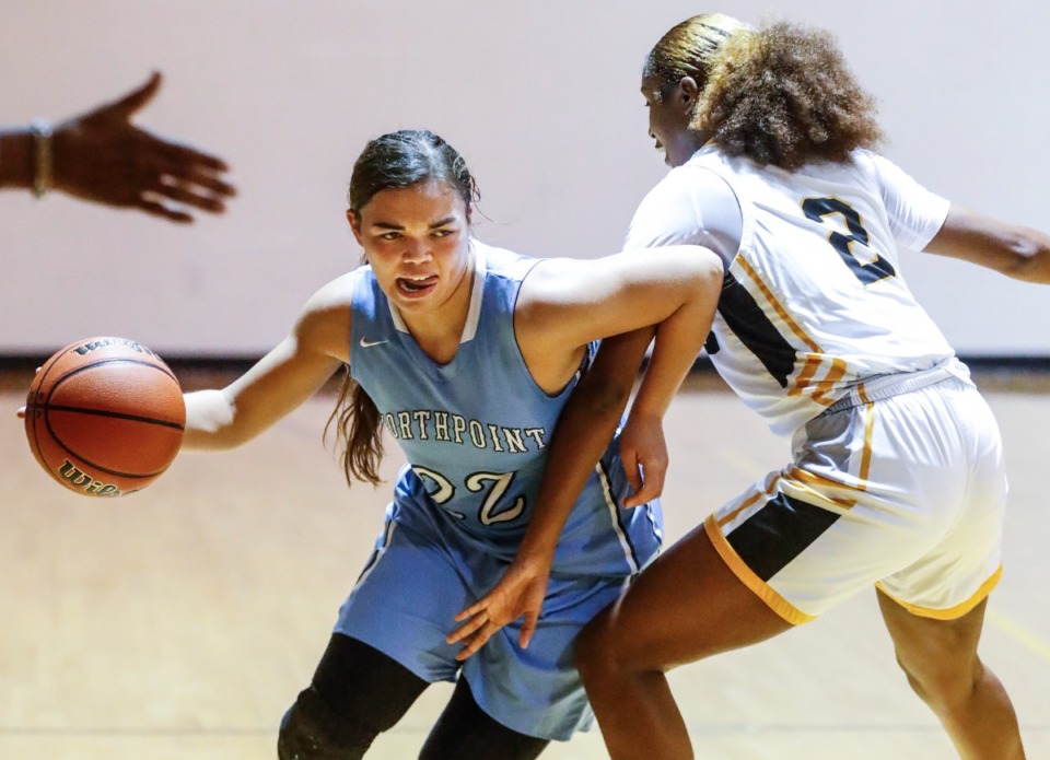 <strong>Northpoint guard Isabella Carlson (left) drives past MAHS defender Serenity Echols (right) on Friday, Dec. 3, 2021.</strong> (Mark Weber/The Daily Memphian)
