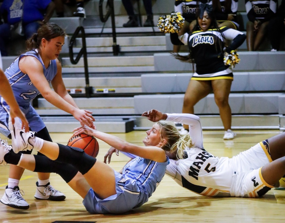 <strong>Northpoint forward Brylee Cherry (middle) grabs a loose ball in the game against MAHS on Friday, Dec. 3, 2021.</strong> (Mark Weber/The Daily Memphian)