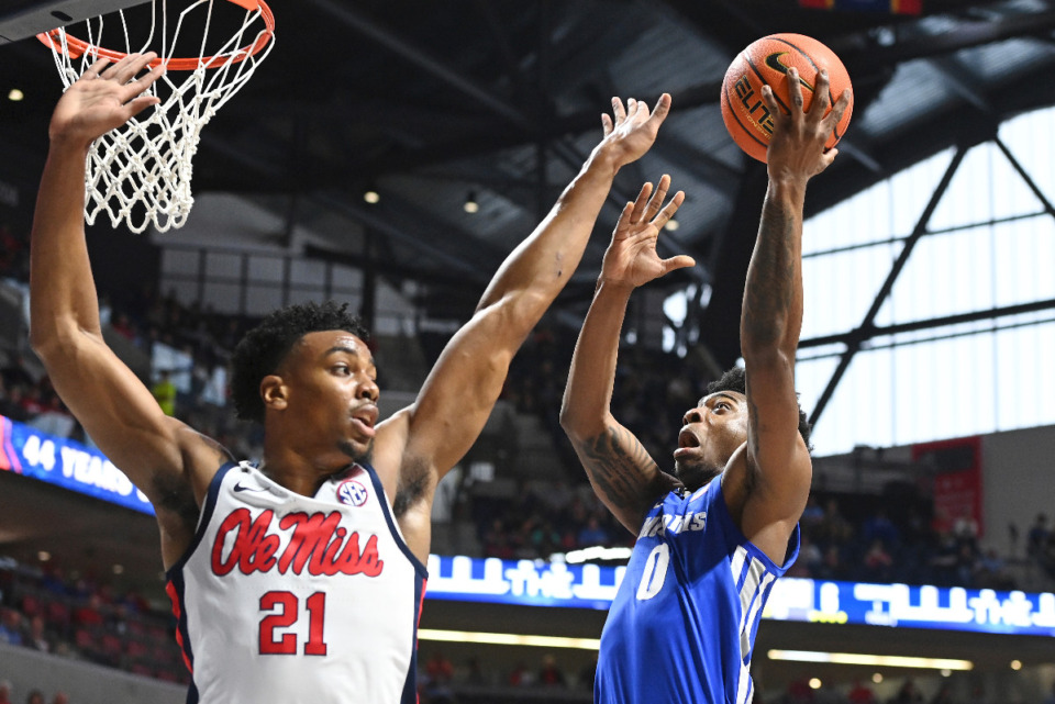 <strong>Memphis guard Earl Timberlake (0) shoots over Ole Miss forward Robert Allen (21) during the first half of an NCAA college basketball game in Oxford, Mississippi, Saturday, Dec. 4, 2021. Ole Miss held off Memphis, 67-63.</strong> (AP Photo/Thomas Graning)