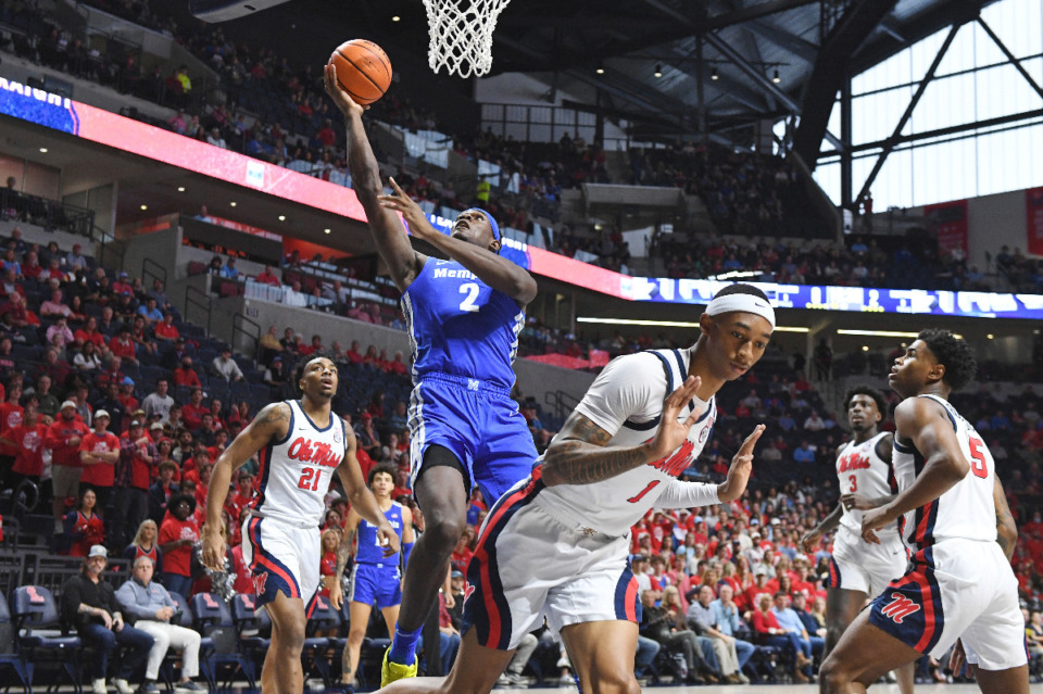<strong>Memphis center Jalen Duren (2) goes up for a shot over Ole Miss guard Austin Crowley (1) during the first half of an NCAA college basketball game in Oxford, Mississippi, Saturday, Dec. 4, 2021.</strong> (AP Photo/Thomas Graning)