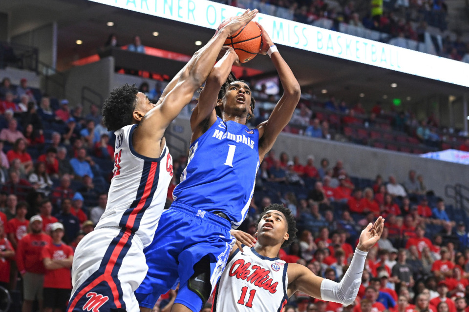 <strong>Memphis forward Emoni Bates (1) takes a shot past Ole Miss forward Robert Allen (21) and guard Matthew Murrell (11) during the first half of an NCAA college basketball game in Oxford, Mississippi, Saturday, Dec. 4, 2021.</strong> (AP Photo/Thomas Graning)