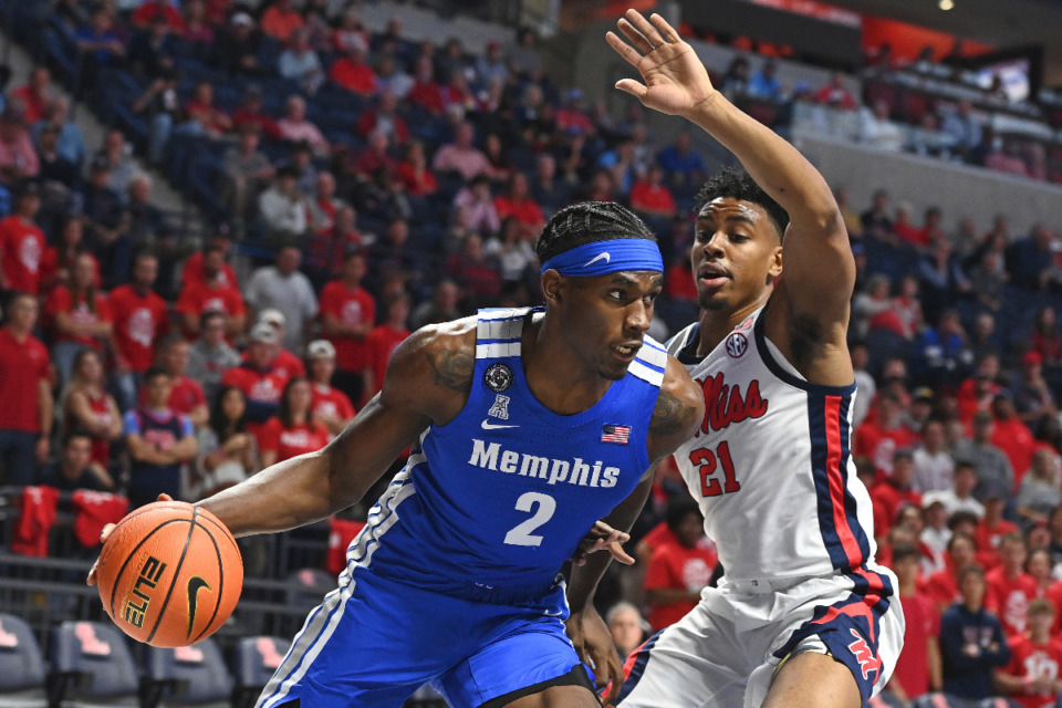 <strong>Memphis center Jalen Duren (2) drives the ball past Ole Miss forward Robert Allen (21) during the first half of an NCAA college basketball game in Oxford, Mississippi, Saturday, Dec. 4, 2021.</strong> (AP Photo/Thomas Graning)