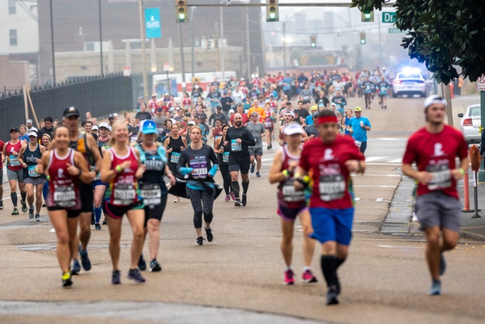 <strong>Runners in the 20th annual St. Jude Memphis Marathon run down Second Street in a misty start of the race Saturday, Dec. 4, 2021.</strong> (Greg Campbell/Special to The Daily Memphian)