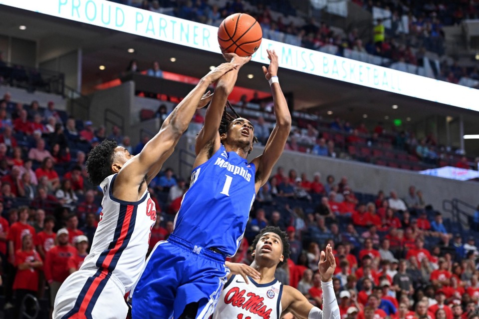 <strong>Memphis forward Emoni Bates (1) takes a shot past Mississippi forward Robert Allen (21) and guard Matthew Murrell (11) during the first half of an an NCAA college basketball game in Oxford, Mississippi, Saturday, Dec. 4, 2021.</strong> (AP Photo/Thomas Graning)