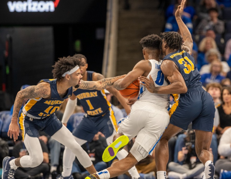 <strong>Memphis guard Earl Timberlake is fouled by Murray State&rsquo;s Tevin Brown and Jordan Skipper-Brown as he drives to the basket at FedExForum on Friday, Dec. 10, 2021.&nbsp;Murray State won 74-72 and delivered Memphis' fourth straight loss.</strong>&nbsp;(Greg Campbell/ Special to The Daily Memphian)