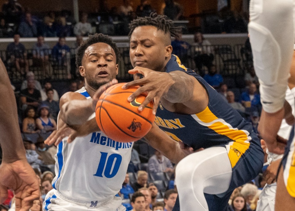 <strong>Alex Lomax goes after a loose ball as Murray State's Trae Hannibal makes his way to the basket at FedExForum on Friday, Dec. 10, 2021.</strong> (Greg Campbell/ Special to The Daily Memphian)