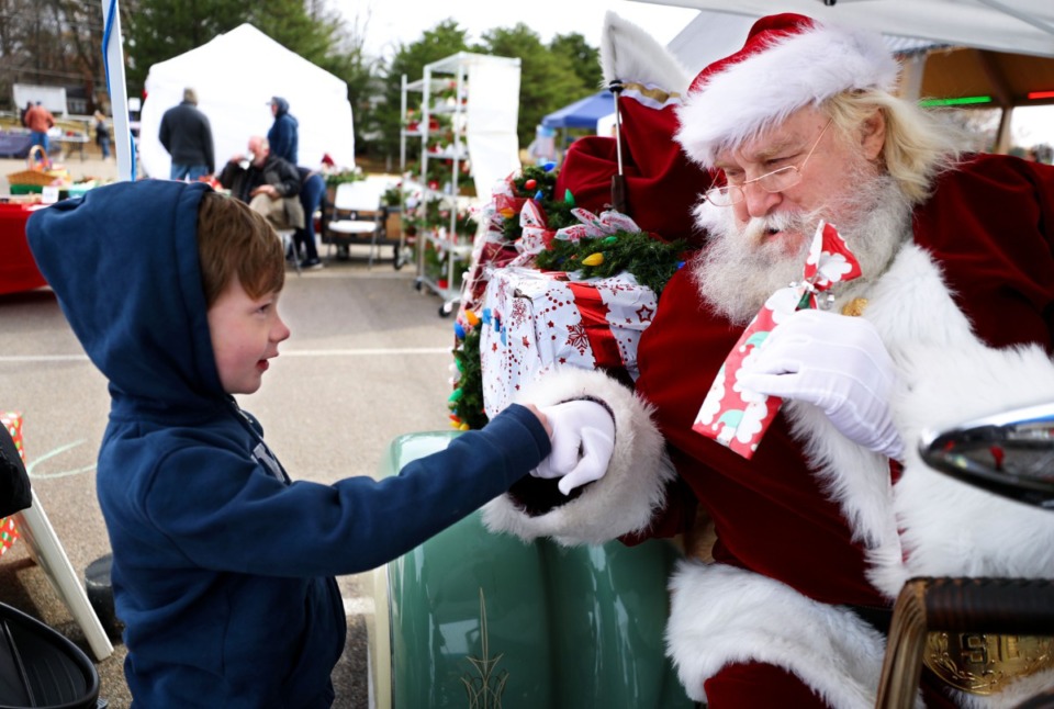 <strong>Colin Horvath fist bumps motorcycle Santa Billy Power at Freeman Park in Bartlett, Dec. 11, 2021.</strong> (Patrick Lantrip/The Daily Memphian)