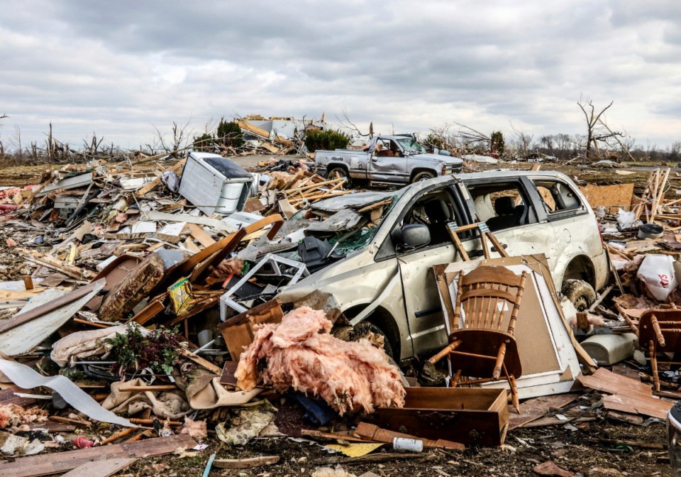 <strong>Damaged vehicles and personal property are strewn over a wide area along Kentucky 81, Saturday, Dec. 11, 2021, in Bremen, Ky, after a devastating tornado swept through the area on Friday night.</strong> (Greg Eans/The Messenger-Inquirer via AP)