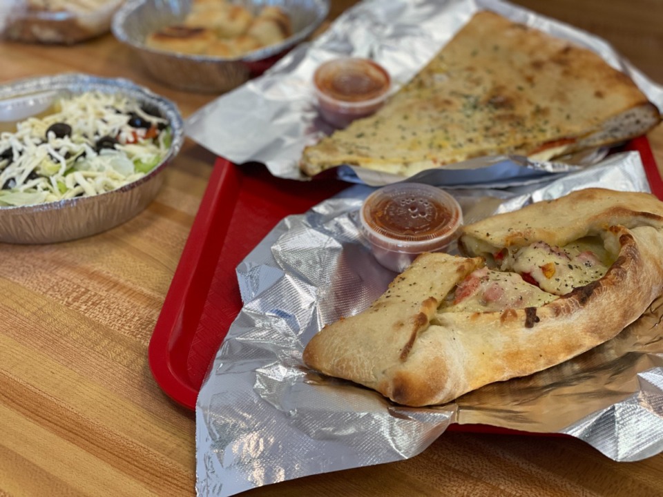 <strong>A sausage roll and a jumbo stuffed slice are two of the numerous pizza and kin available at The Cheesecake Boss Italian Pizzeria.</strong> (Jennifer Biggs/Daily Memphian)