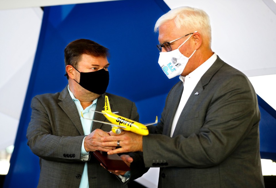 <strong>Memphis International Airport CEO Scott Brockman (right) receives a model Spirit Airlines plane during a Dec. 14, 2021 press conference announcing the company's entry into the Memphis market.</strong> (Patrick Lantrip/Daily Memphian)