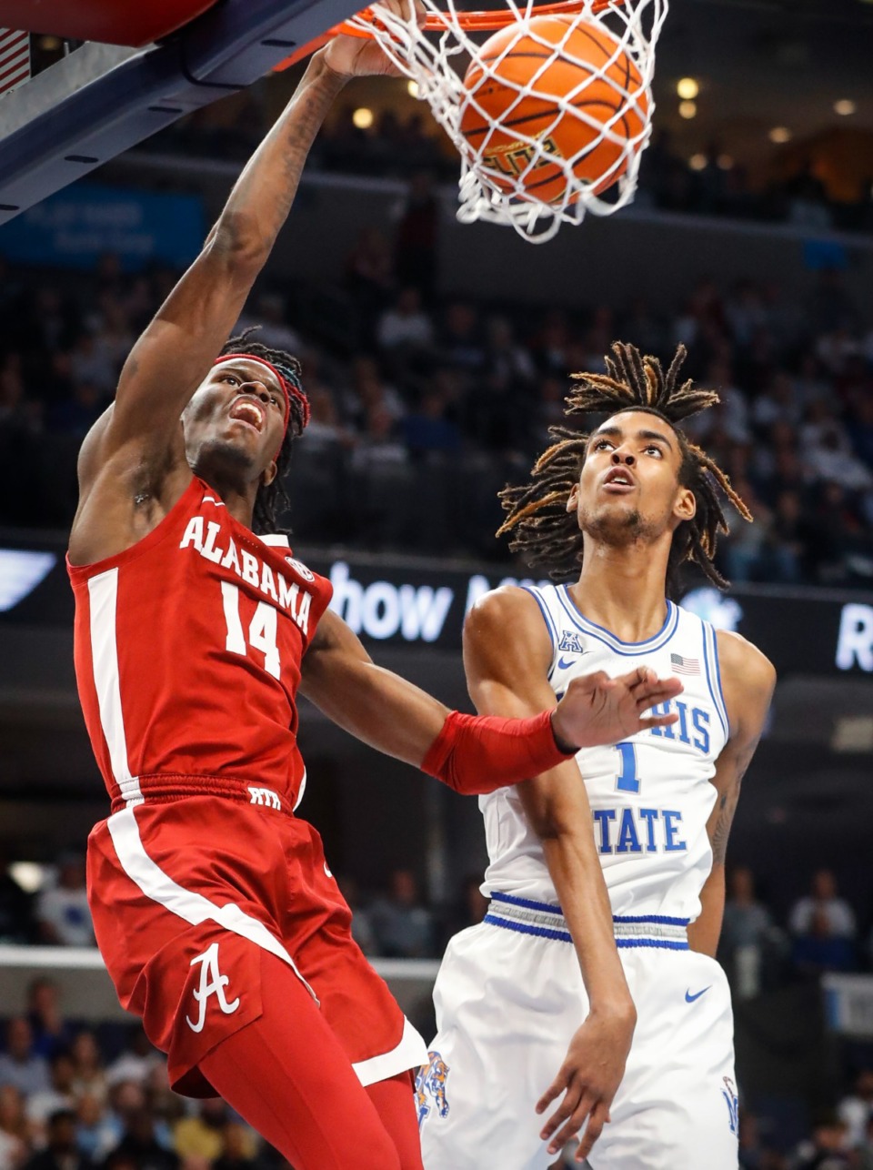 <strong>Tigers defender Emoni Bates (right) looks on as Alabama guard Keon Ellis (left) finishes a dunk on Tuesday, Dec. 14, 2021.</strong> (Mark Weber/The Daily Memphian)