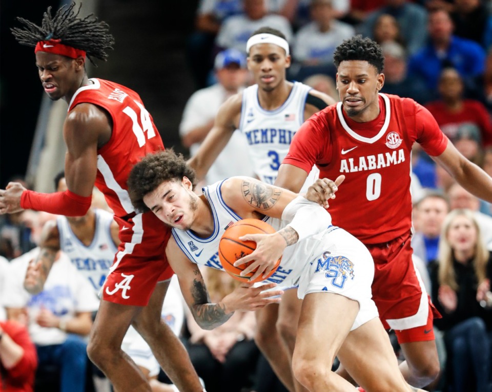 <strong>Tigers guard Lester Quinones (middle) grabs a rebound away from Alabama on Tuesday, Dec. 14, 2021.</strong> (Mark Weber/The Daily Memphian)