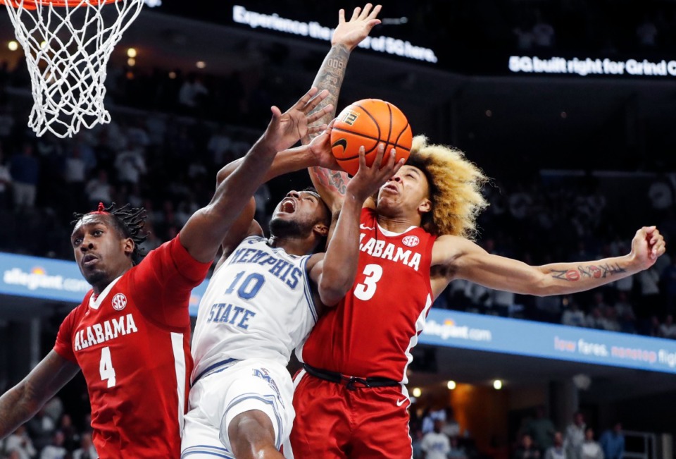 <strong>Tigers guard Alex Lomax (middle) is fouled while driving the lane against Alabama&rsquo;s Juwan Gary (left) and JD Davison (right) on Tuesday, Dec. 14, 2021.</strong> (Mark Weber/The Daily Memphian)
