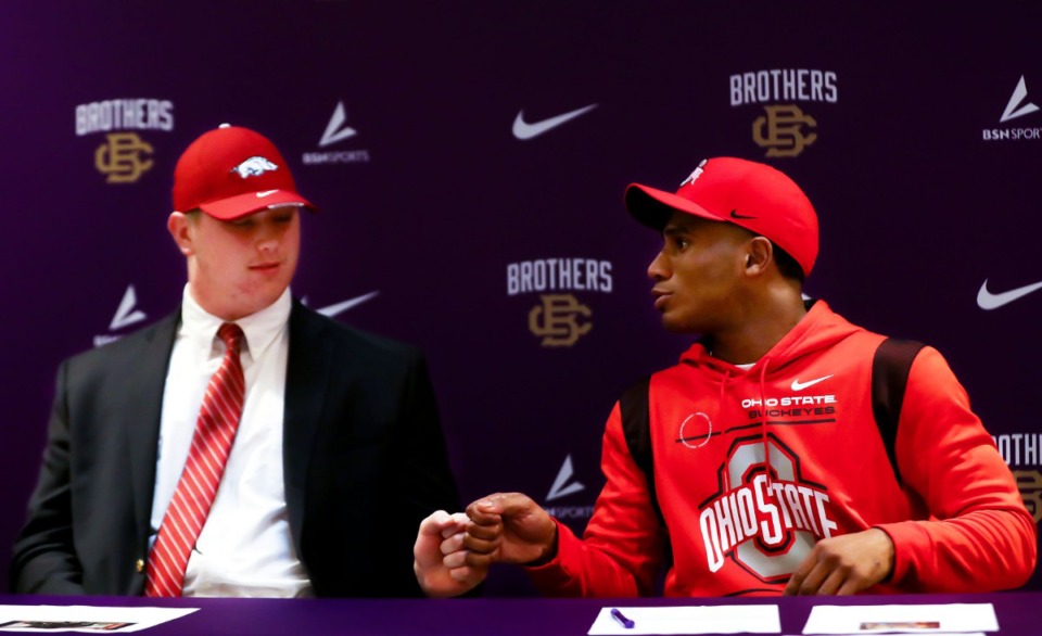 <strong>Ohio State University commit Dallan Hayden (right) fist bumps teammate and University of Arkansas commit Patrick Kutas Jr. during a signing day event at Christian Brothers High School on Wednesday, Dec. 15.</strong> (Patrick Lantrip/Daily Memphian)