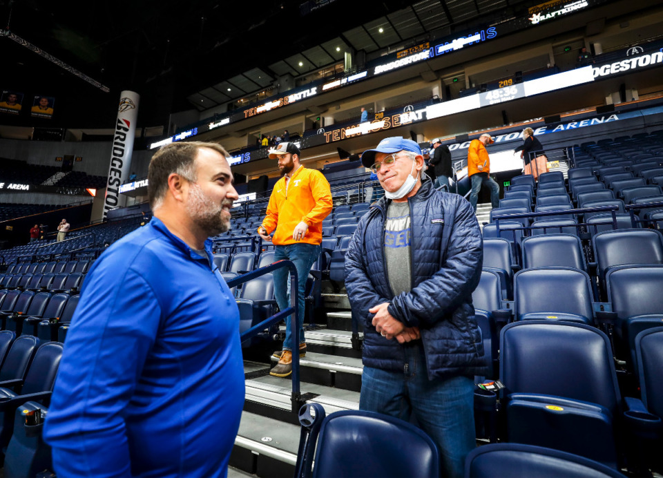 <strong>Memphis fans Clayton Ellis (left) and Marty Kelman (right) talk in the stands after a positive COVID test on the Tigers team canceled their game against Tennessee on Saturday, Dec. 18, 2021 in Nashville.</strong> (Mark Weber/The Daily Memphian)