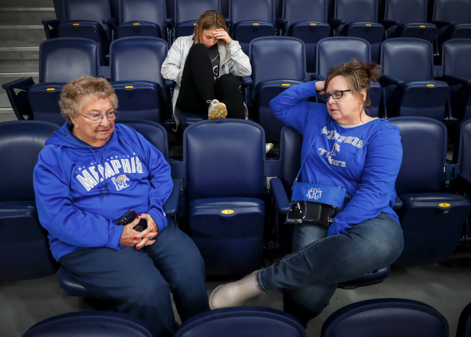 <strong>Memphis fans LaVonne Finley (left), granddaughter Finley Richey (middle) and Kim Richey (right) sit in the stands after a positive COVID test on the Tigers team canceled their game against Tennessee on Saturday, Dec. 18, 2021 in Nashville.</strong> (Mark Weber/The Daily Memphian)