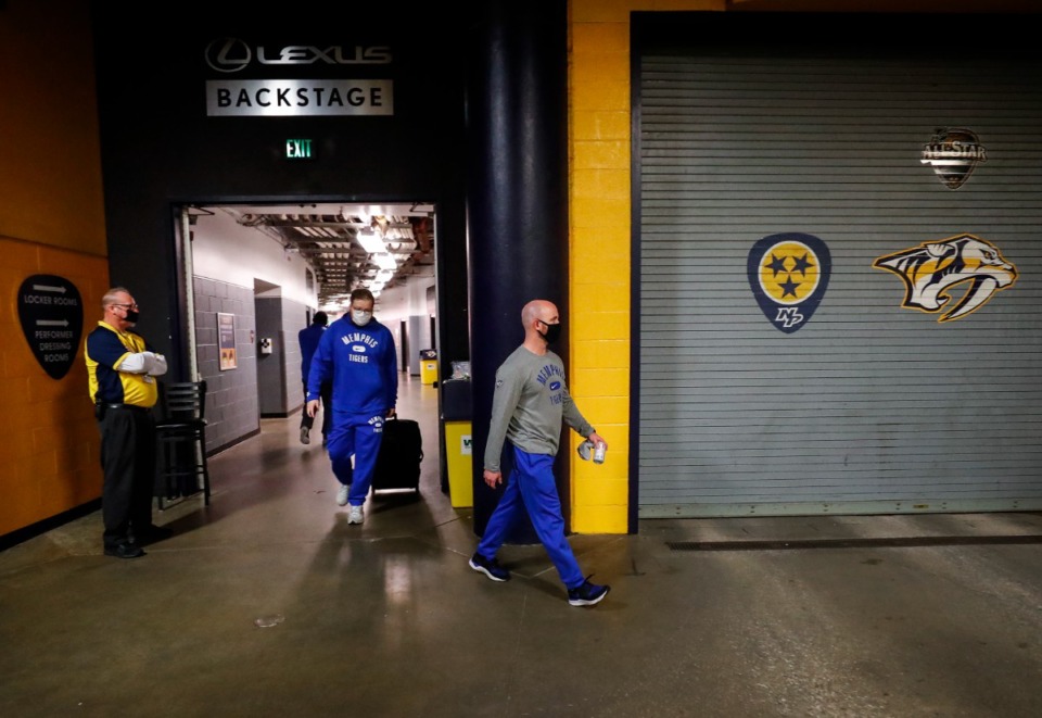 <strong>Memphis basketball team staff members leave the arena after a positive COVID test on the Tigers team canceled their game against Tennessee on Saturday, Dec. 18, 2021 in Nashville.</strong> (Mark Weber/The Daily Memphian)