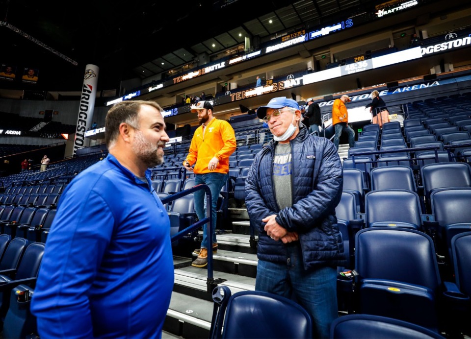 <strong>Memphis fans Clayton Ellis (left) and Marty Kelman chat at Bridgestone Arena in Nashville after a positive COVID test on the Tigers team canceled their game against Tennessee on Saturday, Dec. 18, 2021.</strong> (Mark Weber/The Daily Memphian)