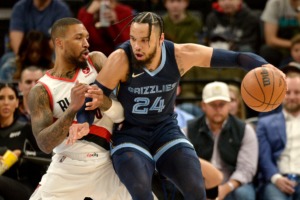 <strong>Memphis Grizzlies forward Dillon Brooks (24) handles the ball against Portland Trail Blazers guard Damian Lillard (0) in the first half of an NBA basketball game Sunday, Dec. 19, 2021, at FedExForum.</strong> (AP Photo/Brandon Dill)