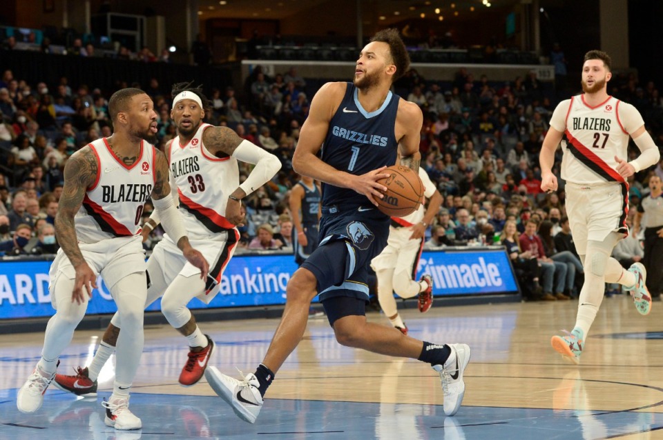 <strong>Memphis Grizzlies forward Kyle Anderson (1) drives to the basket against Portland Trail Blazers guard Damian Lillard (0) in the second half of an NBA basketball game Sunday, Dec. 19, 2021, in Memphis, Tennessee.</strong> (AP Photo/Brandon Dill)