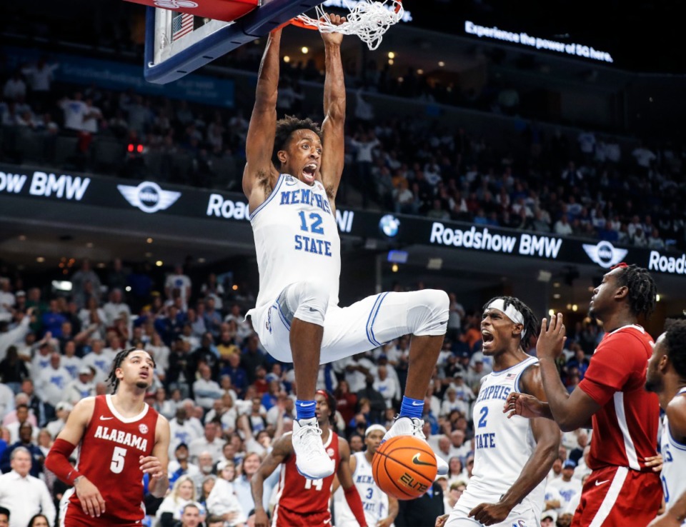 <strong>Memphis Tigers forward DeAndre Williams (top) celebrates a dunk against Alabama during action on Tuesday, Dec. 14, 2021</strong>. (Mark Weber/The Daily Memphian)