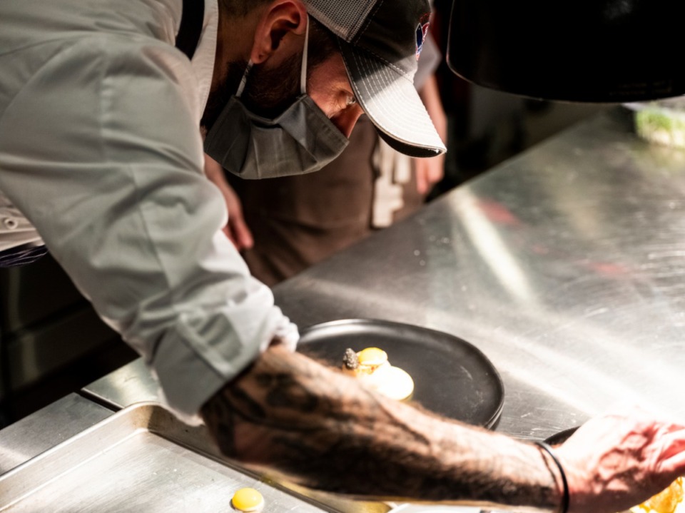 <strong>Chef Dave Krog works to prepare a dish at Dory in East Memphis, January 22, 2021. Dory is a new restaurant in East Memphis owned by chef Dave Krog and his wife, Amanda.</strong> (Brad Vest/Special to The Daily Memphian)