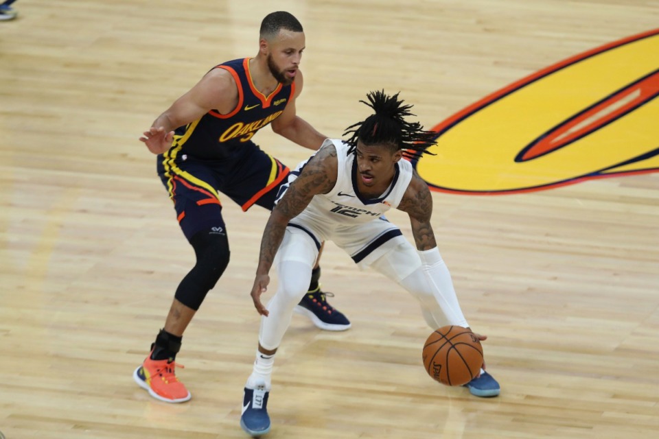 <strong>The Memphis Grizzlies will face the Golden State Warriors Thursday, Dec. 23 in San Francisco. Ja Morant (right, in a May 21 file photo) drives against Golden State Warriors' Stephen Curry during an NBA basketball Western Conference play-in game.</strong> (AP Photo/Jed Jacobsohn)
