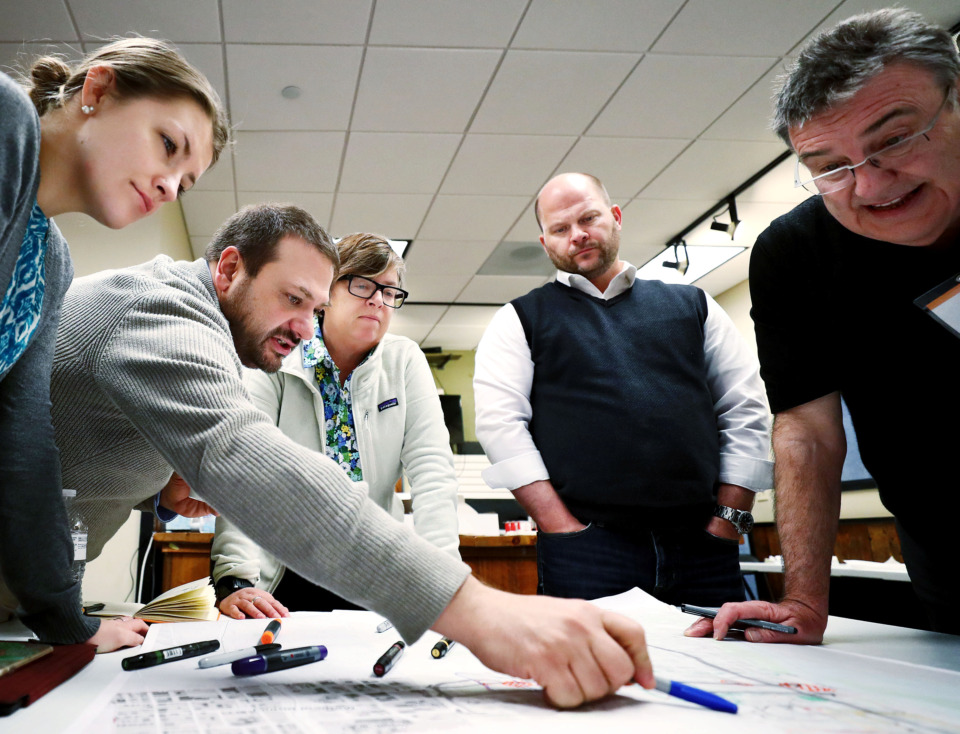 <strong>Jessica Darling (from left), Ralph DeNisco, Nancy Locke, Ryan Dawson and David Walters, all members of the design firm Stantec, discuss potential design revisions to the Danny Thomas roadway. A session was held as part of the Downtown Memphis Commission's master plan to discuss how Downtown can be strengthened as a regional asset and better support economic growth.</strong> (Houston Cofield/Daily Memphian)