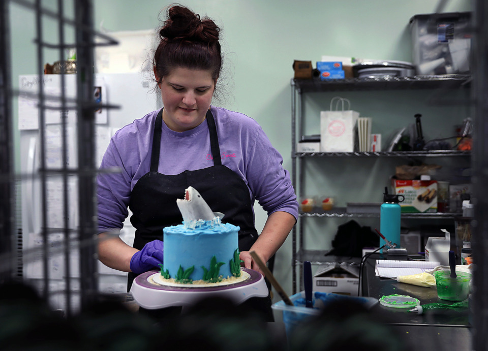 <strong>Morgan Kelly of Crave Sweets in Arlington prepares a custom shark cake for a client on Thursday, Feb. 28.&nbsp;&ldquo;Basically, if it&rsquo;s a dessert, we do it,&rdquo; co-owner Lana Hickey said. &ldquo;We&rsquo;re working on expanding our name outside of the region, with this being our home base for all of our baked goods.&rdquo;</strong> (Patrick Lantrip/Daily Memphian)