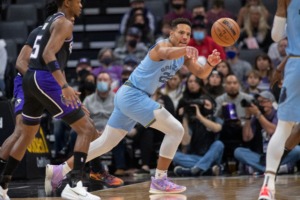 <strong>Memphis Grizzlies guard Desmond Bane (22) passes the ball past Sacramento Kings guard De'Aaron Fox (5) during the first quarter of an NBA basketball game in Sacramento, Calif., Sunday, Dec. 26, 2021.</strong> (AP Photo/Randall Benton)