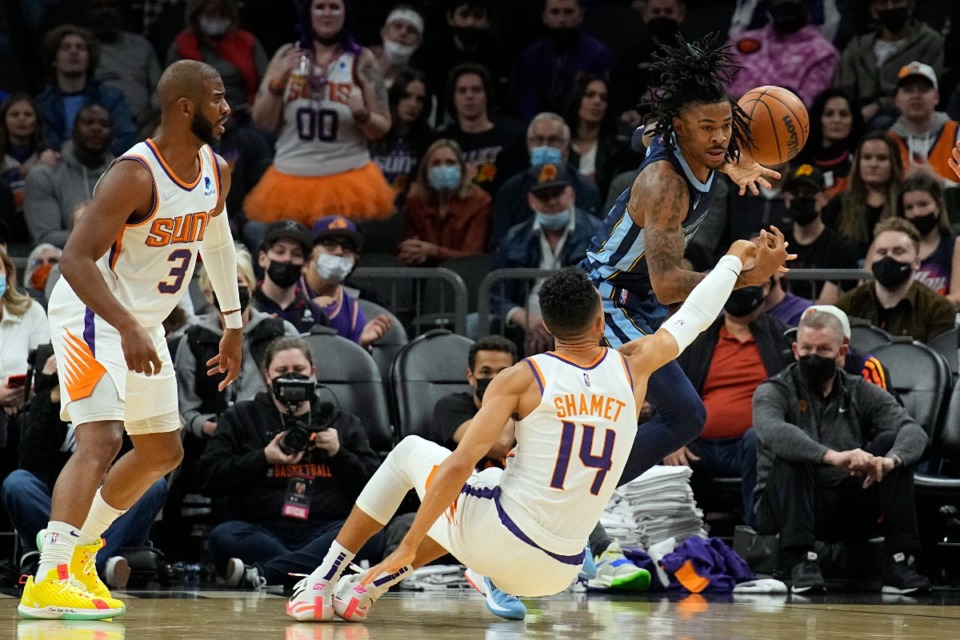 <strong>Grizzlies guard Ja Morant (12) charges the lane against the Phoenix Suns on Dec. 27, 2021, in Phoenix.</strong> (Rick Scuteri/AP)