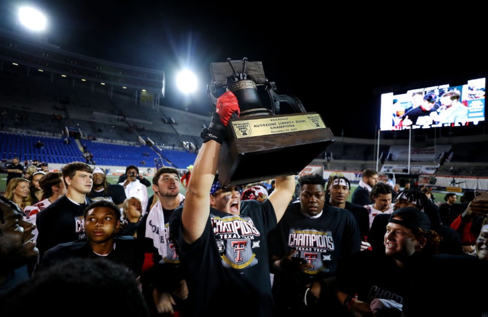 <strong>Texas Tech University lineman Gabe Cavazos Jr. (68) holds up the Liberty Bowl trophy after his team defeated Mississippi State University at the 63rd AutoZone Liberty Bowl on Dec. 28, 2021.</strong> (Patrick Lantrip/Daily Memphian)