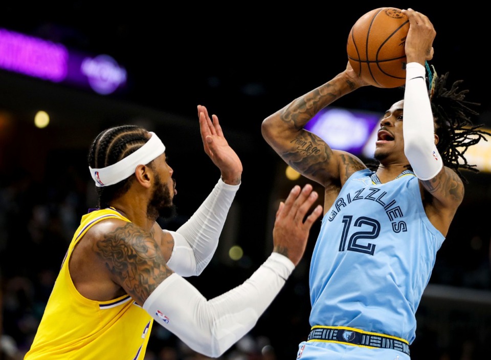 <strong>Grizzlies guard Ja Morant (12) shoots over Los Angeles Lakers forward Carmelo Anthony (7) during the Dec. 29, 2021, game at FedExForum.</strong> (Patrick Lantrip/Daily Memphian)