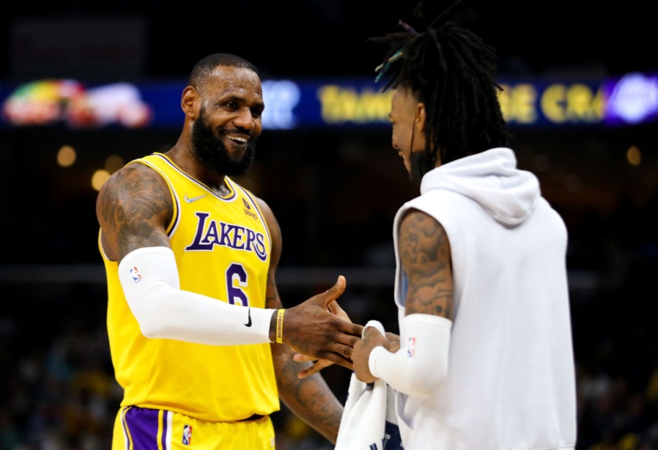 <strong>Grizzlies guard Ja Morant (12) jokes with Los Angeles Lakers forward LeBron James (6) after a delay-of-game call on Dec. 29 at FedExForum.</strong> (Patrick Lantrip/Daily Memphian)