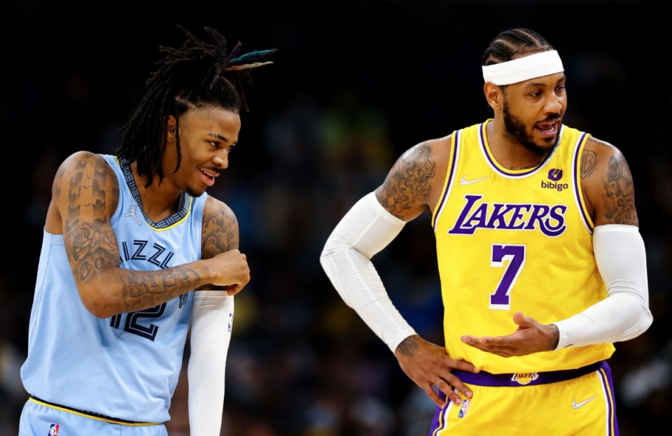 <strong>Grizzlies guard Ja Morant (12) laughs while Los Angeles Lakers forward Carmelo Anthony (7) talks with a referee on Dec. 29 at FedExForum.</strong> (Patrick Lantrip/Daily Memphian)