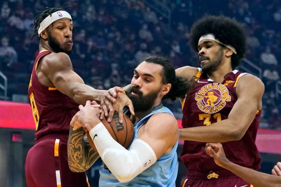 <strong>Grizzlies center Steven Adams, middle, grabs a rebound ahead of Cleveland&rsquo;s Lamar Stevens and Jarrett Allen on Tuesday, Jan. 4, in Cleveland.</strong> (Tony Dejak/Associated Press)