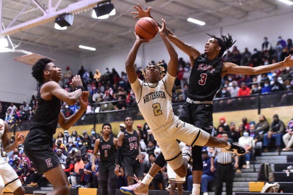 <strong>Whitehaven&rsquo;s William Carver (2) goes to the basket against Markese Washington (3) of Memphis East</strong>&nbsp;<strong>on Jan 4, 2022.</strong> (Justin Ford/Special to The Daily Memphian)